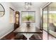 Dining area with wood floors, decorative chandelier, farm table with bench, and views to the backyard at 6904 W Ashby Dr, Peoria, AZ 85383