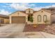Charming single-story home featuring a tile roof, arched windows, and a low-maintenance desert landscape at 6904 W Ashby Dr, Peoria, AZ 85383