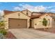 Charming single-story home featuring a tile roof, arched windows, and a two-car garage at 6904 W Ashby Dr, Peoria, AZ 85383