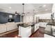 Open concept kitchen with a large island, white cabinets, stainless steel appliances, and hardwood floors at 6904 W Ashby Dr, Peoria, AZ 85383