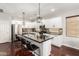 Modern kitchen with white cabinets, a large island with seating, stainless steel appliances, and dark countertops at 6904 W Ashby Dr, Peoria, AZ 85383