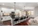 Modern kitchen with white cabinets, a large island with seating, stainless steel appliances, and dark countertops at 6904 W Ashby Dr, Peoria, AZ 85383