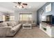 Spacious living room with neutral sectional sofa, ceiling fan, coffee table, and modern entertainment center at 6904 W Ashby Dr, Peoria, AZ 85383