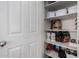 Organized pantry with shelving stocked with food and storage containers behind a white paneled door at 6904 W Ashby Dr, Peoria, AZ 85383