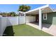 This backyard includes a white fence and artificial turf at 6960 W Peoria Ave # 237, Peoria, AZ 85345