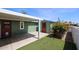 Backyard showing artificial turf, white fence, shed, and rock landscaping at 6960 W Peoria Ave # 237, Peoria, AZ 85345