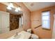 Bathroom with marble tile shower, large vanity, and framed mirror providing a well-lit and stylish space at 6960 W Peoria Ave # 237, Peoria, AZ 85345