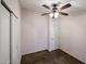 Carpeted bedroom featuring a ceiling fan, standard closet, and a door leading to other rooms at 6960 W Peoria Ave # 237, Peoria, AZ 85345