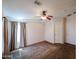 Well-lit bedroom with neutral carpet, ceiling fan, and natural light creating a bright and inviting atmosphere at 6960 W Peoria Ave # 237, Peoria, AZ 85345