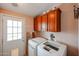 Functional laundry area featuring a white washer, dryer, storage cabinets, and exterior door at 6960 W Peoria Ave # 237, Peoria, AZ 85345