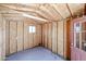 View of unfinished shed interior with OSB walls, ceiling, window, electrical outlets and concrete floors at 6960 W Peoria Ave # 237, Peoria, AZ 85345