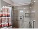 Accessible shower with grab bars and shower seat featuring a tiled surround and modern fixtures for safety and comfort at 6960 W Peoria Ave # 237, Peoria, AZ 85345