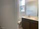 Bright bathroom with double vanity, modern fixtures, and a large mirror at 7320 E Hackamore Ln, San Tan Valley, AZ 85143