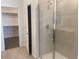 Shower room featuring glass doors and views of a carpeted walk-in closet on the left at 7320 E Hackamore Ln, San Tan Valley, AZ 85143