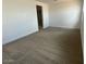 Neutral bedroom featuring a carpeted floor, window, and doorway to a walk-in closet at 7320 E Hackamore Ln, San Tan Valley, AZ 85143
