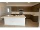 Modern kitchen with a large island, stainless steel appliances, and ample cabinet space at 7320 E Hackamore Ln, San Tan Valley, AZ 85143