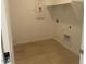 Bright laundry room with tiled floors and connections for a washer and dryer at 7320 E Hackamore Ln, San Tan Valley, AZ 85143