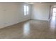 Spacious living room with neutral tile flooring and a large window at 7320 E Hackamore Ln, San Tan Valley, AZ 85143