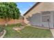 Well-kept backyard featuring lush green grass, gravel landscaping, and a view of the home's exterior at 735 W Ivanhoe St, Gilbert, AZ 85233