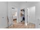 Bright bathroom with access to the main bedroom and walk-in closet featuring light-colored walls and wood-look floors at 735 W Ivanhoe St, Gilbert, AZ 85233