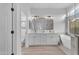 Bright bathroom features double vanity, large mirror, a modern soaking tub, and a glass-enclosed shower at 735 W Ivanhoe St, Gilbert, AZ 85233