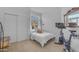 Bright bedroom with closet, large window, and a workout bike, promoting a healthy lifestyle at 735 W Ivanhoe St, Gilbert, AZ 85233