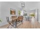 Dining area with a wooden table and bench, open to a modern kitchen with bar seating and bright light at 735 W Ivanhoe St, Gilbert, AZ 85233
