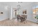 Bright dining area features wood-look floors, a modern light fixture, and a rustic wood and metal dining set at 735 W Ivanhoe St, Gilbert, AZ 85233