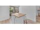 Kitchen island features white barstools and a wood countertop for food preparation at 735 W Ivanhoe St, Gilbert, AZ 85233
