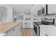 Well-lit kitchen with stainless steel appliances, white cabinets, and a sleek design at 735 W Ivanhoe St, Gilbert, AZ 85233