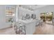 Modern, bright kitchen with white cabinets, stainless appliances, and a breakfast bar at 735 W Ivanhoe St, Gilbert, AZ 85233