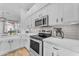 Bright, modern kitchen featuring white cabinets, stainless steel appliances, and quartz countertops at 735 W Ivanhoe St, Gilbert, AZ 85233