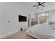 Bright main bedroom with white walls, soft carpet, ceiling fan, and large window with natural light at 735 W Ivanhoe St, Gilbert, AZ 85233