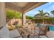 Relaxing covered patio with comfortable seating, string lights, and a beautiful view of the pool at 735 W Ivanhoe St, Gilbert, AZ 85233