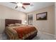 Bedroom with a ceiling fan, large bed, and a serene atmosphere at 749 E Desert Moon Trl, San Tan Valley, AZ 85143