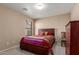 Cozy bedroom featuring a bed, window with blinds, carpet, and wood dresser and chair at 749 E Desert Moon Trl, San Tan Valley, AZ 85143