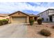 Charming single-story home with a two-car garage, desert landscaping and a cozy covered porch entrance at 749 E Desert Moon Trl, San Tan Valley, AZ 85143