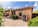Rear exterior view with covered patio, desert landscaping and AC unit at 749 E Desert Moon Trl, San Tan Valley, AZ 85143