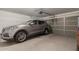 Spacious garage with vehicle parked inside, ample storage space, and automatic door opener at 749 E Desert Moon Trl, San Tan Valley, AZ 85143