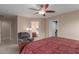 Main bedroom with a large bed, ceiling fan, and relaxing chair at 749 E Desert Moon Trl, San Tan Valley, AZ 85143