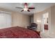 Main bedroom featuring a large bed, ceiling fan, and natural lighting at 749 E Desert Moon Trl, San Tan Valley, AZ 85143