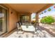 Inviting covered patio area featuring a table with chairs, perfect for outdoor relaxation and dining at 749 E Desert Moon Trl, San Tan Valley, AZ 85143