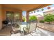 Charming covered patio with outdoor dining set, ideal for entertaining and enjoying outdoor living at 749 E Desert Moon Trl, San Tan Valley, AZ 85143