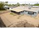 Birds eye of backyard featuring a large yard, covered patio, and mature trees at 7513 E Roosevelt St, Scottsdale, AZ 85257