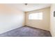 Bedroom showcasing a neutral-toned carpet, a window, and electrical outlets at 7513 E Roosevelt St, Scottsdale, AZ 85257