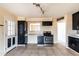 View of kitchen with stainless steel stove and view to an adjacent room at 7513 E Roosevelt St, Scottsdale, AZ 85257