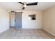 Spacious living room with a sliding barn door and view to kitchen at 7513 E Roosevelt St, Scottsdale, AZ 85257