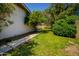 Well-maintained backyard featuring lush green grass, mature trees, and a pathway at 7811 N 46Th Ave, Glendale, AZ 85301