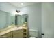 Bathroom with mirrored walls, marble countertop and storage at 7811 N 46Th Ave, Glendale, AZ 85301