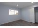 Bright bedroom featuring closet with sliding doors and updated flooring at 7811 N 46Th Ave, Glendale, AZ 85301